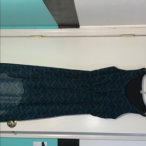 Dark turquoise colored dress with black patterns.